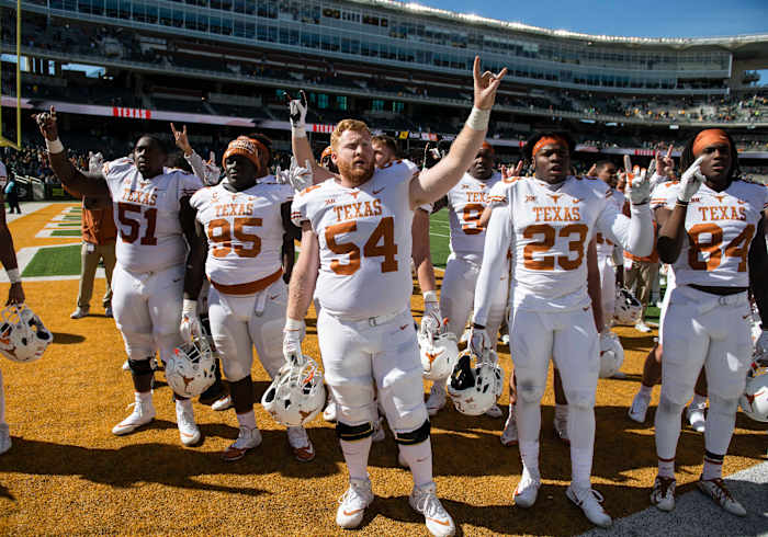 Texas Longhorns offensive lineman Terrell Cuney (51) and defensive lineman Poona Ford (95) and offensive lineman Garrett Graf (54) and defensive back Jordan Strickland (23) and wide receiver Lil'Jordan Humphrey (84) celebrate the win over the Baylor Bears at McLane Stadium. The Longhorns defeat the Bears 38-7. © Jerome Miron-USA TODAY Sports